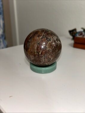 Polished Brown Marble Sphere on Green Stand